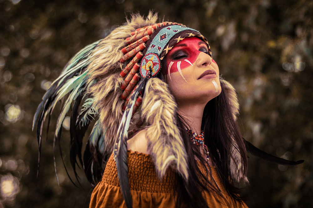 Profile of Native American Shaman woman in headdress and face paint