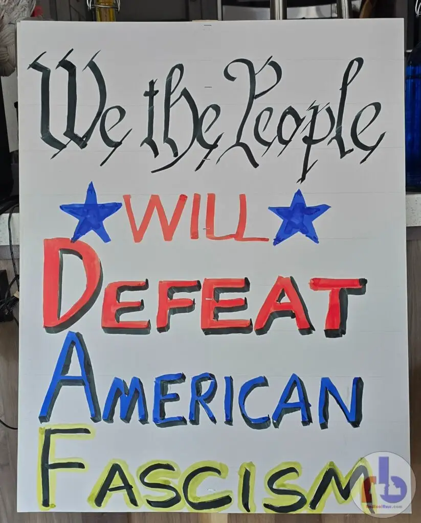 Russ's protest sign that reads "We The People will Defeat American Fascism"